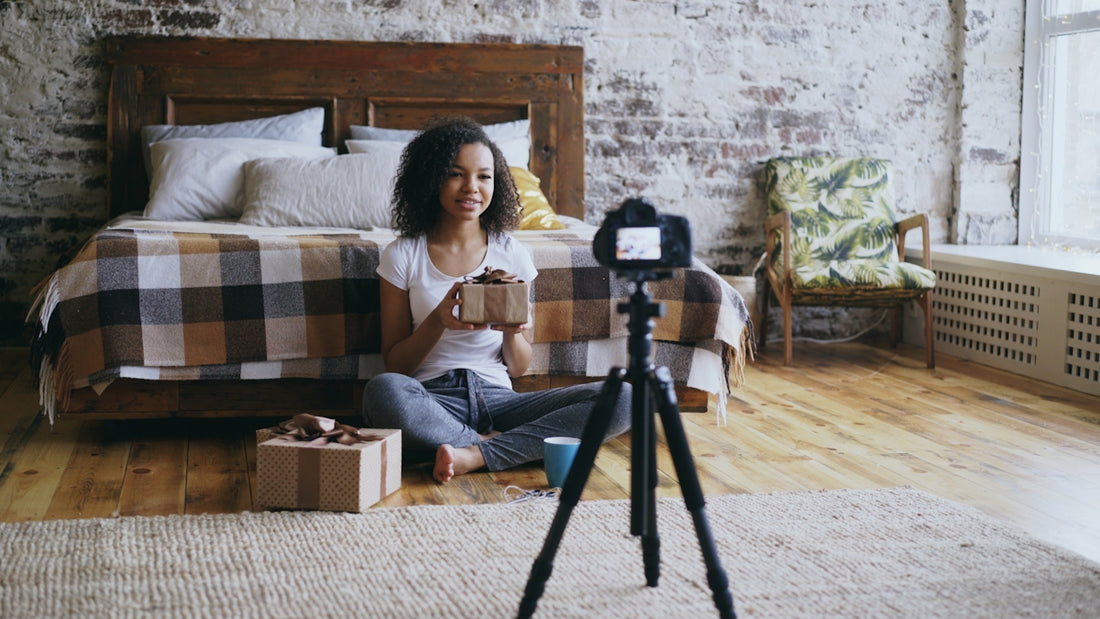 Woman unboxing gifts in front of camera