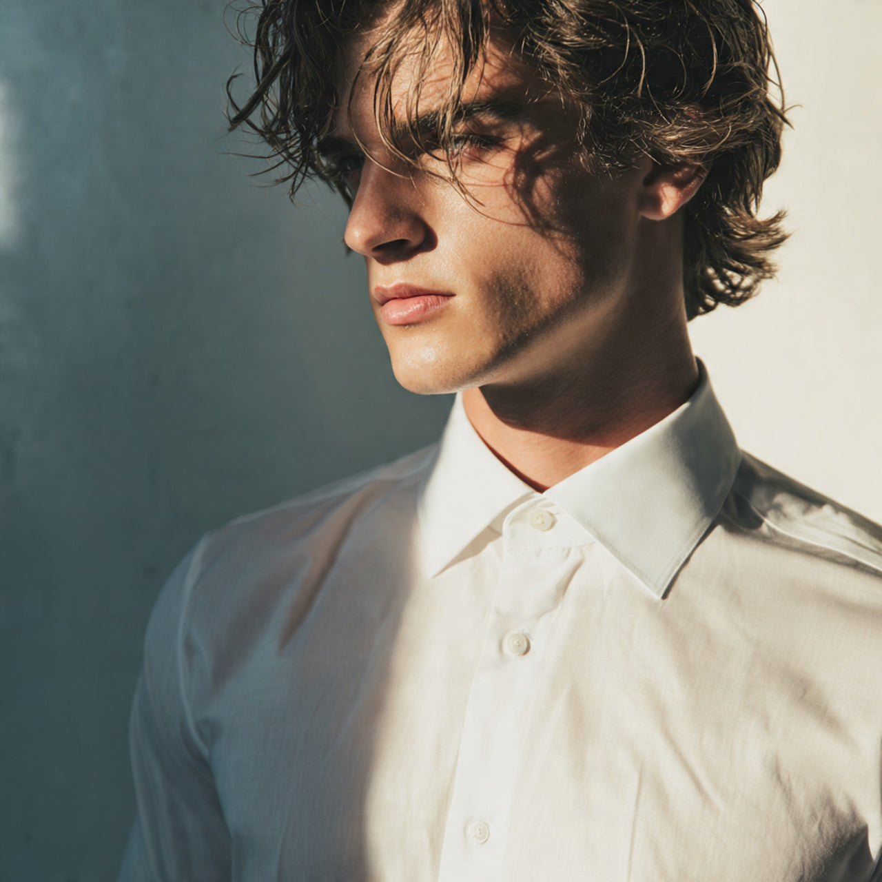 Male model in a crisp tailored shirt, soft directional lighting, high-fashion editorial vibe, premium textile details, minimal luxury background